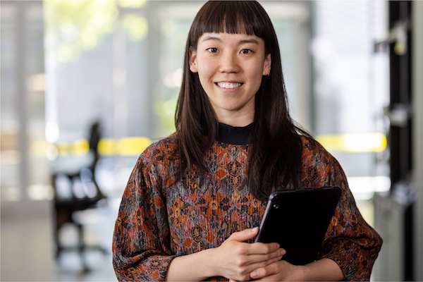 Woman smiling and holding tablet